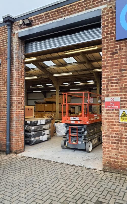 Shutter open showing warehouse interior and access equipment
