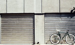 An Industrial Roller Shutter with a bike leaning up against.