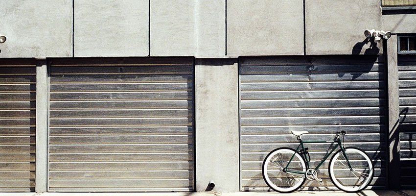 An Industrial Roller Shutter with a bike leaning up against.